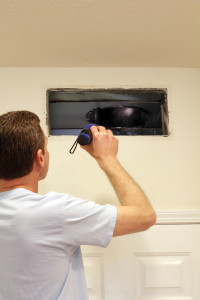 HVAC tech inspecting a duct in an Afton, MN home